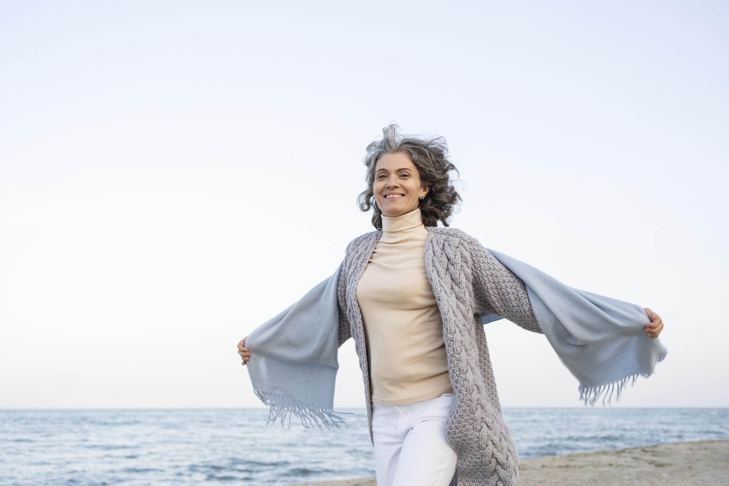 older woman enjoying her time beach