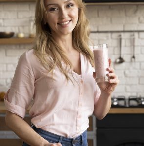 medium shot woman holding smoothie