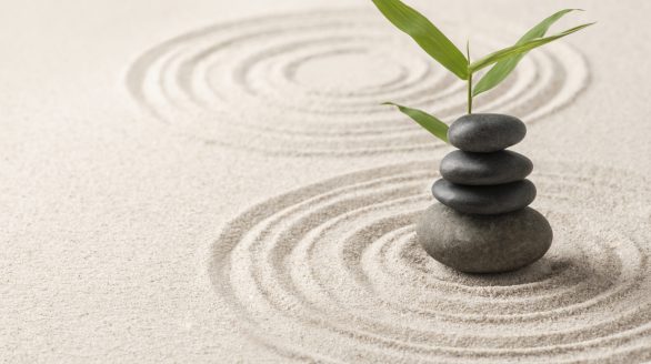 stacked zen stones sand background art of balance concept